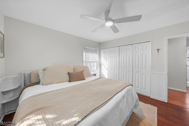 bedroom with dark hardwood / wood-style floors, ceiling fan, and a closet