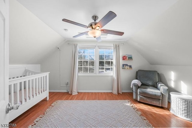 bedroom with wood-type flooring, lofted ceiling, and ceiling fan