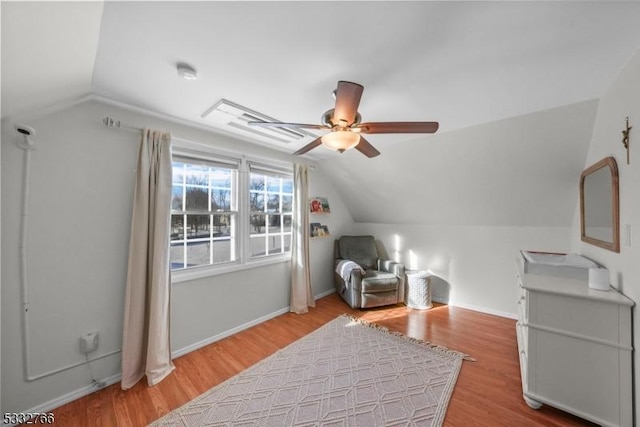 living area with ceiling fan, lofted ceiling, and light wood-type flooring