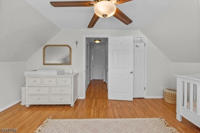 unfurnished bedroom featuring ceiling fan, lofted ceiling, and light wood-type flooring