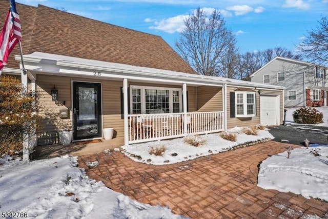 exterior space with a garage and covered porch