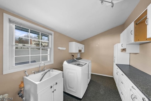 laundry area featuring cabinets, washer and dryer, sink, and dark carpet