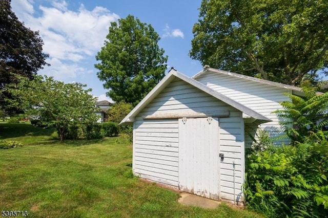 view of outdoor structure with a lawn