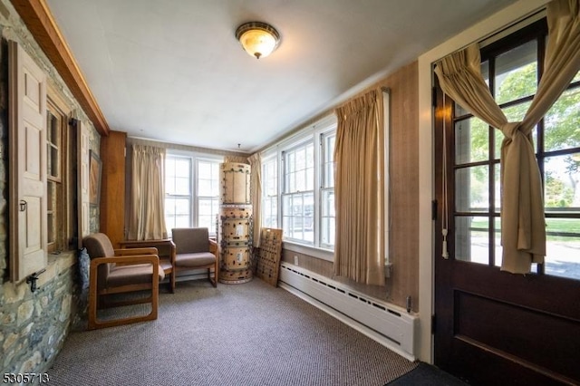 living area with carpet floors and baseboard heating