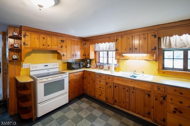 kitchen featuring white electric range oven and sink