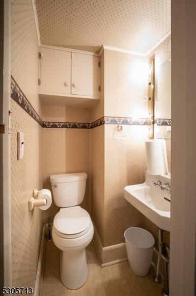 bathroom with toilet and tile patterned flooring