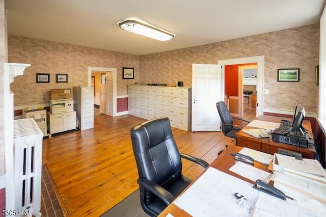 office space with wood-type flooring