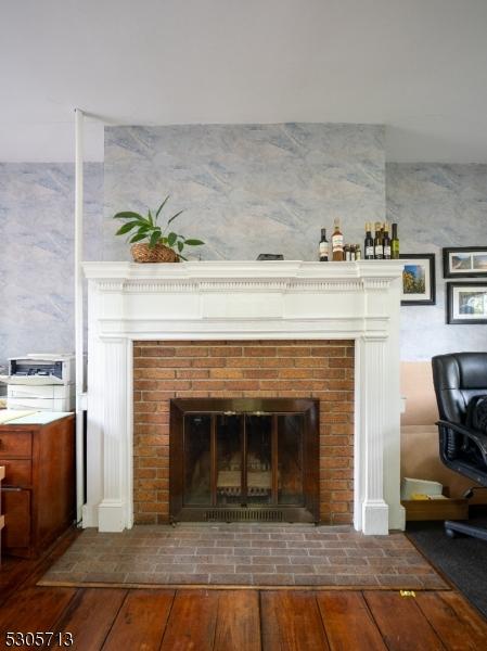 room details with a brick fireplace and wood-type flooring