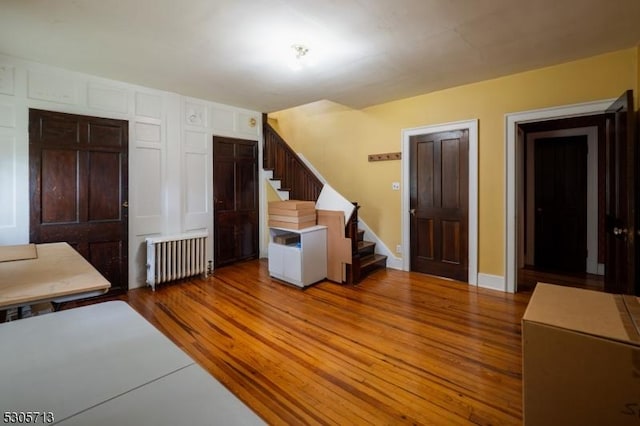 interior space with light hardwood / wood-style flooring and radiator heating unit