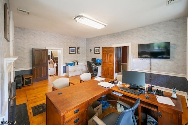 office area with light hardwood / wood-style floors