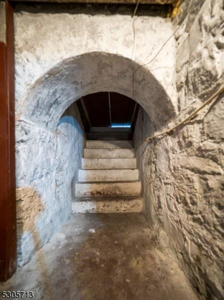 staircase with concrete floors