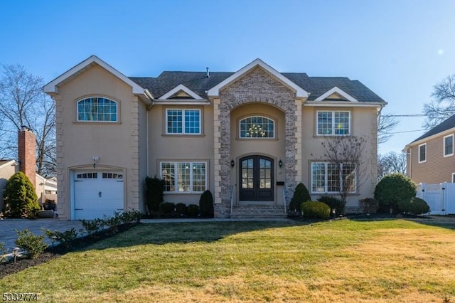 view of front of house with a front yard, french doors, and a garage