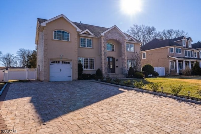 view of front of property featuring a front lawn and a garage