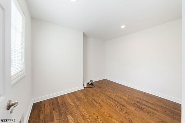 spare room with hardwood / wood-style floors