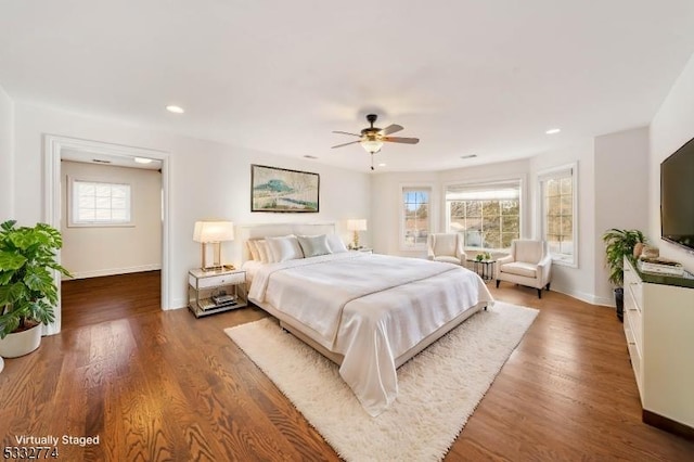 bedroom featuring ceiling fan and dark wood-type flooring