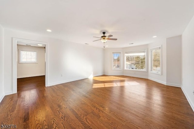 spare room featuring ceiling fan and dark hardwood / wood-style flooring