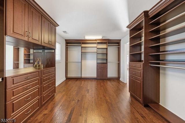 walk in closet featuring dark hardwood / wood-style flooring