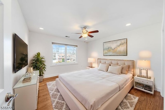 bedroom with ceiling fan and hardwood / wood-style flooring