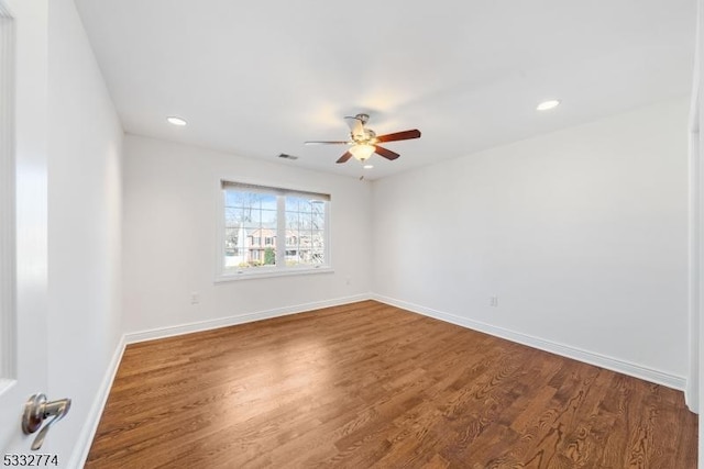 empty room featuring ceiling fan and hardwood / wood-style floors