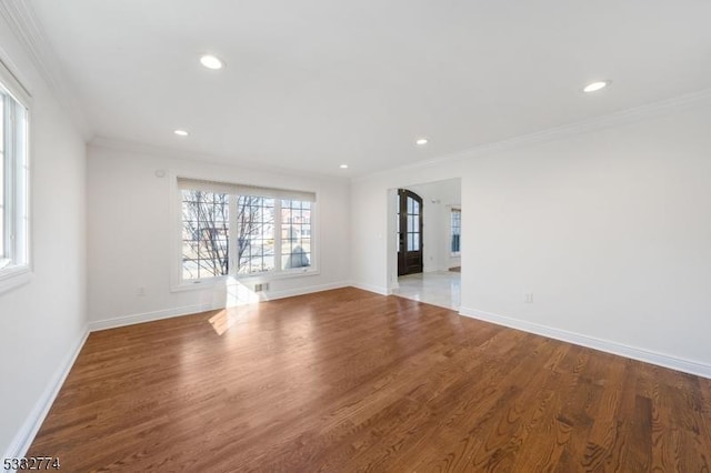 empty room featuring crown molding and hardwood / wood-style floors