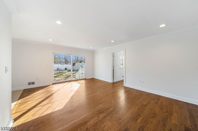 spare room featuring dark hardwood / wood-style flooring and ornamental molding