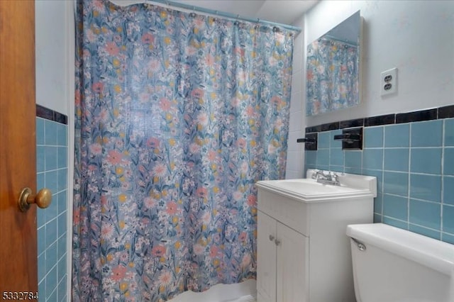 bathroom with a shower with curtain, toilet, tile walls, and vanity