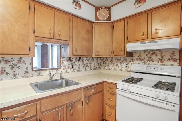 kitchen featuring white gas range oven and sink