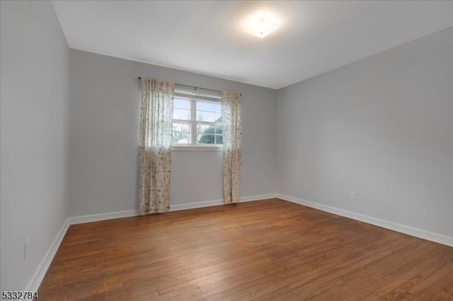 empty room with hardwood / wood-style floors