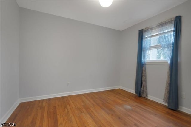 spare room featuring hardwood / wood-style flooring