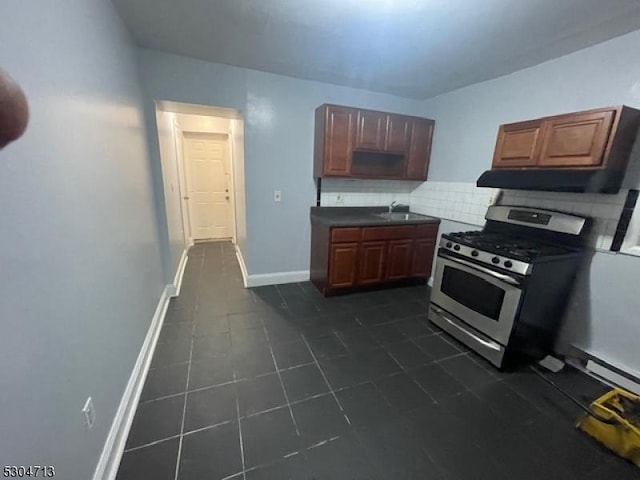 kitchen featuring backsplash, sink, and gas range