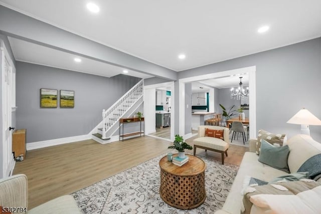 living room featuring wood-type flooring and a chandelier