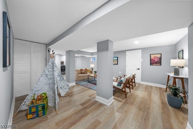 playroom with light hardwood / wood-style flooring