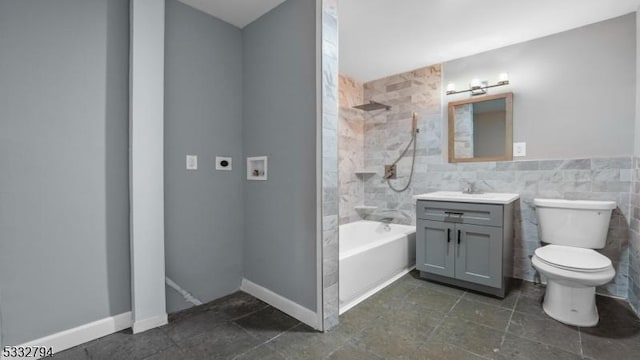 full bathroom featuring toilet, tiled shower / bath, and vanity