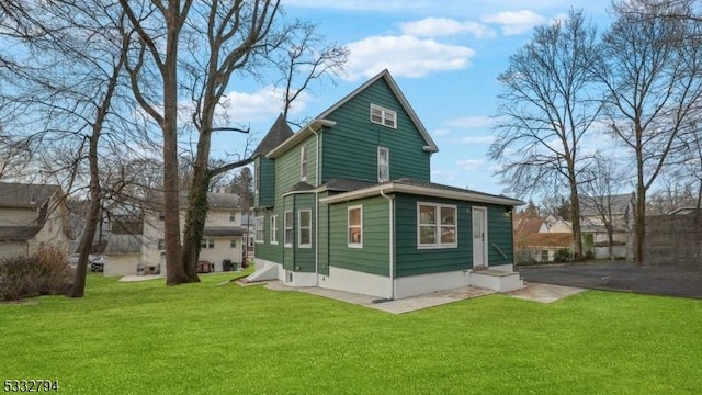 rear view of house with a lawn