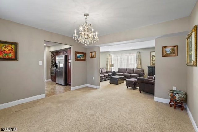 carpeted living room with a chandelier