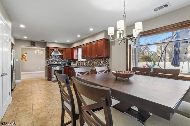 tiled dining room featuring a chandelier and sink