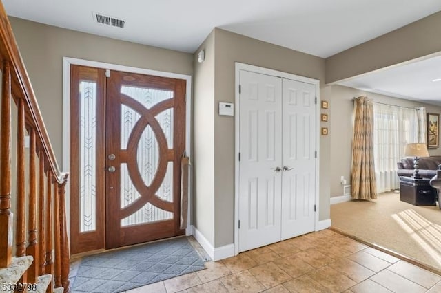 foyer entrance with light carpet