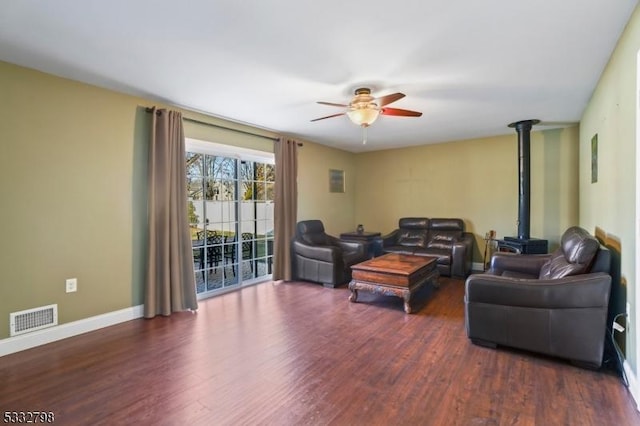 living room with ceiling fan and dark hardwood / wood-style flooring