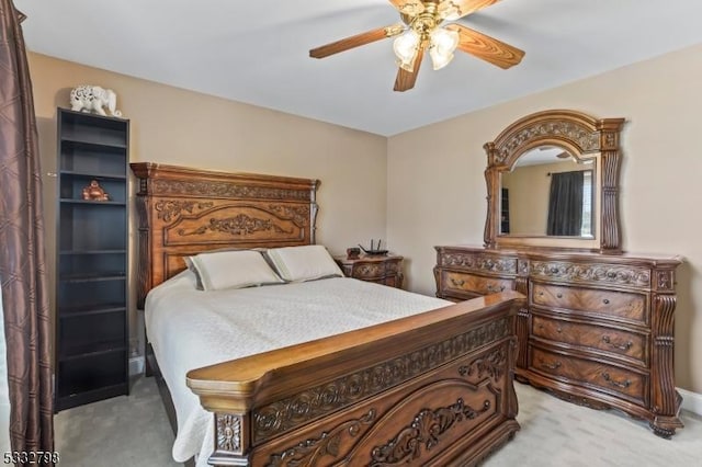 bedroom with ceiling fan and light carpet