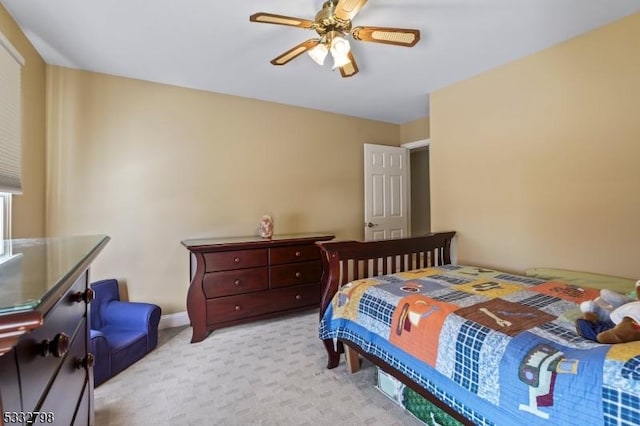 bedroom with ceiling fan and light colored carpet