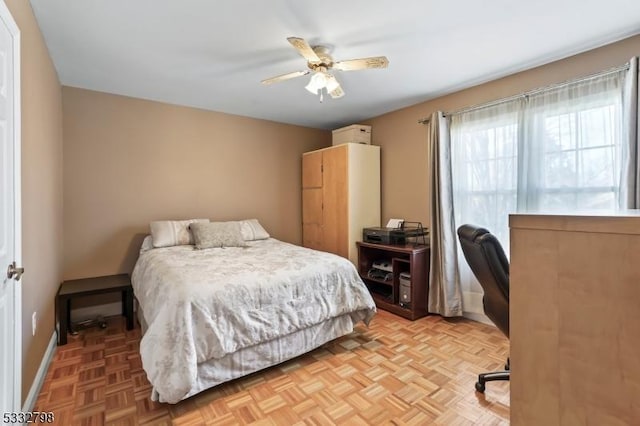 bedroom with ceiling fan and light parquet flooring