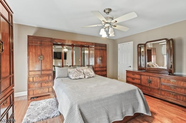 bedroom with ceiling fan and light hardwood / wood-style flooring