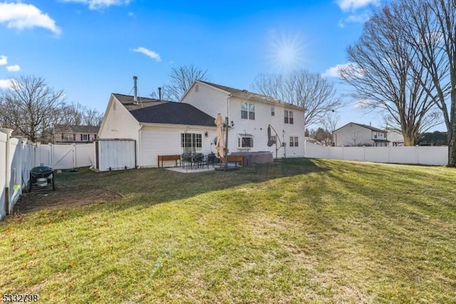 rear view of property with a yard and a patio area