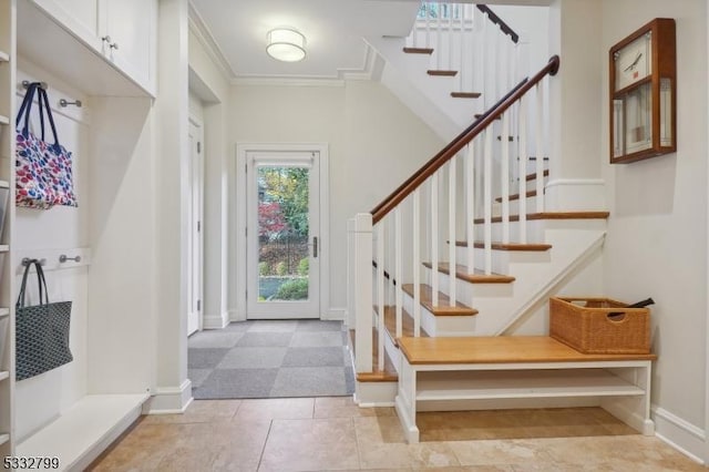 mudroom with light tile patterned flooring and ornamental molding