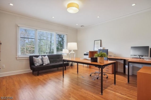 office space with ornamental molding and light hardwood / wood-style floors