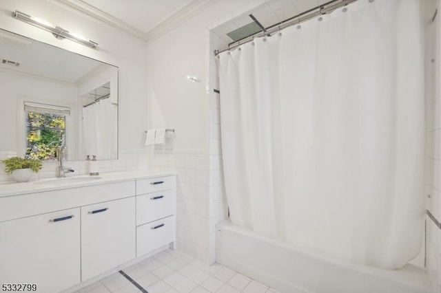 bathroom with tile patterned floors, shower / bath combo with shower curtain, tile walls, ornamental molding, and vanity