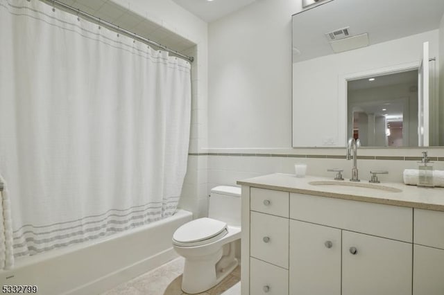 full bathroom featuring shower / tub combo, tile walls, tasteful backsplash, toilet, and vanity