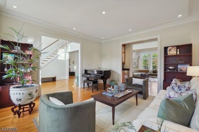 living room featuring ornamental molding and light hardwood / wood-style flooring