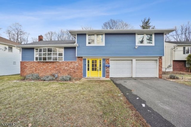 split level home with a front lawn and a garage