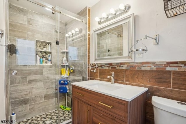 bathroom with toilet, walk in shower, and vanity